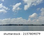 Daylight view of riverside with clouded blue sunny sky, rural riverside scene in Asia