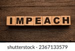 Small photo of Impeach, text words typography written on wooden lettering, politic and governance concept