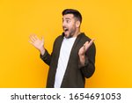 Man over isolated yellow background with surprise facial expression