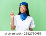 Small photo of Airplane stewardess African american woman over isolated background intending to realizes the solution while lifting a finger up