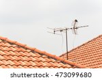 Tv Antenna On Red Roof