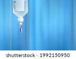 Small photo of Drop counter with blue ward curtains on background. Close up covid concept. Dripping medical perfusion close up equipment in clinic background.