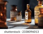 Poison bottle with skull and bones stands among pharmaceutical bottles. Danger sign, symbol of death. Concept background on poison poisoning, pharmaceutical, chemistry, medical, old science topic. 