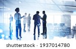 Small photo of Silhouettes of diverse business people working together, toned image of office interior and skyscrapers. Concept of modern office with managers, partners