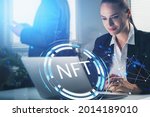 Smiling attractive businesswoman working on laptop, non-fungible token hologram, nft with network circuit. Concept of crypto art and technology