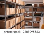 Small photo of Goods packages lying on storehouse racks, waiting for transportration in empty storage. Products cardboard boxes on high shelves in shop distribution department warehouse