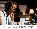 Small photo of Close up of african american seamstress in tailoring studio struggling to find ideas for upcoming haute couture runway show. Couturer thinking of fashion designs for bespoken sartorial collection