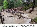 fast flooding and logs and debris against pedestrian bridge