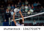 Small photo of Girl Volleyball player and setter setting the ball for a spiker during a game