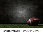 American football on green grass, on dark background. Team sport concept