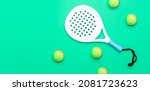 Small photo of White professional paddle tennis racket and balls on mint color background. Horizontal sport theme poster, greeting cards, headers, website and app