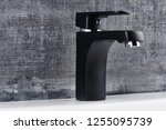 Plumbing. The interior of the bathroom. Faucet sink on black and white background.
