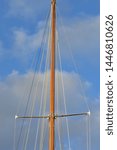 Small photo of Wooden mast of classic yacht with shrouds supported by spreaders and forestay/backstay and halyards.