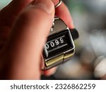 Small photo of Handheld 4-Digit Tally Counter Clicker in Male Hand