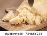 Small photo of traditional grana padano italian cheese on olive board