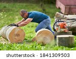 Small photo of Strong lumberjack manhandling the logs