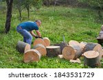 Small photo of Strong lumberjack manhandling the logs