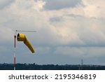 Yellow Windsock Against Cloudy...