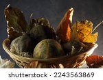 Small photo of ASSORTMENT OF SPOILT FALLEN DRY FRUIT AND DEAD LEAVES IN A BASKET ON A TABLE TOP