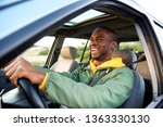 Side portrait of happy african american man driving car