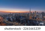 Small photo of Panoramic skyline with modern architecture of Dubai business bay and downtown towers day to night transition timelapse. Aerial view with canal and construction site after sunset
