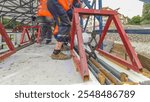 Tram rails at the stage of their installation and integration into concrete plates on the road. Filling by liquid resin for reduction of vibration and noise. The process reconstruction of tram tracks