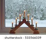 Advent candlestick with seven electric lights on window sill