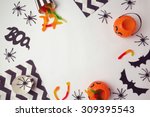 Halloween holiday background with spiders and candy. View from above
