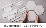 Small photo of Interior design and home decoration - different shapes of white ceramic and gres tiles. Designer choosing bathroom or kitchen renovation materials. Captured from above (top view, flat lay).