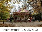 Small photo of Wroclaw, Poland - October 30, 2022: Carousel with white horses and resting townspeople in the Staromiejski park