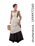Young prairie woman with apron looking back and holding skirt and a basket isolated on white