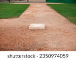 Small photo of Selective focus low angle view of a baseball infield looking toward home from third base