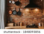details of a cozy kitchen interior with a brick wall