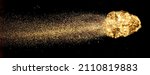 Piece of gold or golden nugget with visible gold shining comet tail ath the dark background. 