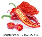 Fresh red chilli peppers, cross section of chilli pepper and ground cayenne pepper with seeds isolated on white background.