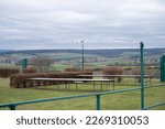 Small photo of Model airfield in Schaafheim with wind shield during cloudy day, strong crosswind, countryside, Germany