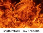 Small photo of Abstract red fire natural background with blaze. Beautiful dangerous firestorm abstract texture. Atmospheric dispersion, defocus (soft focus), motion blur from fire, high temperature from flames.