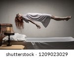 Woman Levitating Over Bed  ...