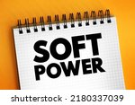 Small photo of Soft power - ability to attract co-opt rather than coerce, text concept on notepad