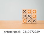 Small photo of Business marketing strategy planning concept. Wooden block tic tac toe board game including copy space