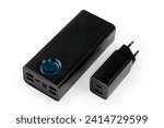 Small photo of Power bank with input and output USB and other standards ports, charger with AC Europlug and different USB output sockets on a white background
