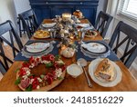 Loaded gourmet holiday table with fine bone China at Christmas.