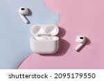 New headphone apple AirPods 3 on pink and blue color background