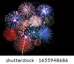 Beautiful red and blue fireworks display lights up the sky during night time celebration 