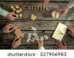 Businessmen planning business strategy while holding puzzle pieces, creating ideas with light bulb drawn on paper and rearranging wooden blocks. Conceptual of teamwork, strategy, vision or education. 