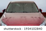 Small photo of dirty red car windshield wipers covered with a layer of dust after long-term disuse, abandoned vehicles in the parking lot front view, nobody.