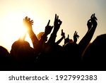 Raised hands of many people at...