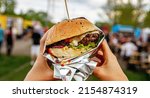 Small photo of Hamburger at outdoor street food market festival in a park