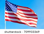 waving flag in the blue sky ... | Shutterstock . vector #709933369