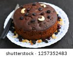 Small photo of Plum cake made with dried fruit, raisins, cashew nuts, almond etc. Tasty home made cake flavored with cinnamon and spices for sale on Christmas and new year Kerala India.